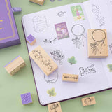 Tsuki ‘Enchanted Garden’ Stamp Set  on dotted notebook with washi stickers on sage green background