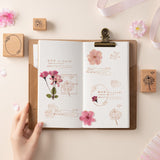 Cherry blossom themed wooden stamps stamped on Hinoki travel notebook with dried flowers