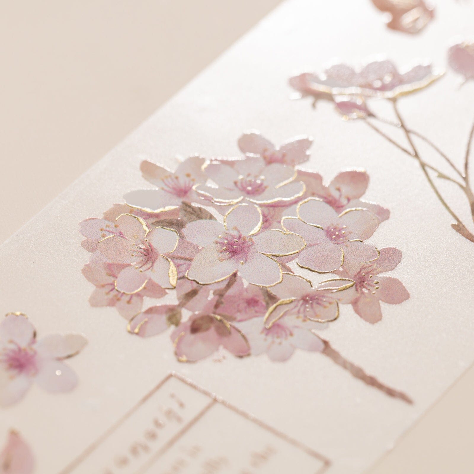 Close up of cherry blossom illustration on Hinoki into the blossom PET tape with raised gold foil effect