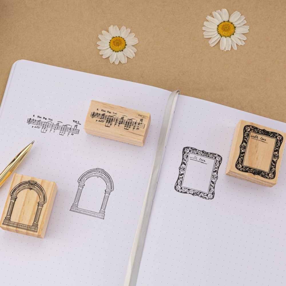 Frame stamps and music note stamps on white bullet journal dotted paper