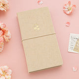Beige linen kraft paper travel notebook with sakura gold foil icon