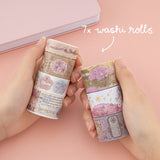 Hands holding 7x washi rolls of sakura breeze by Notebook Therapy