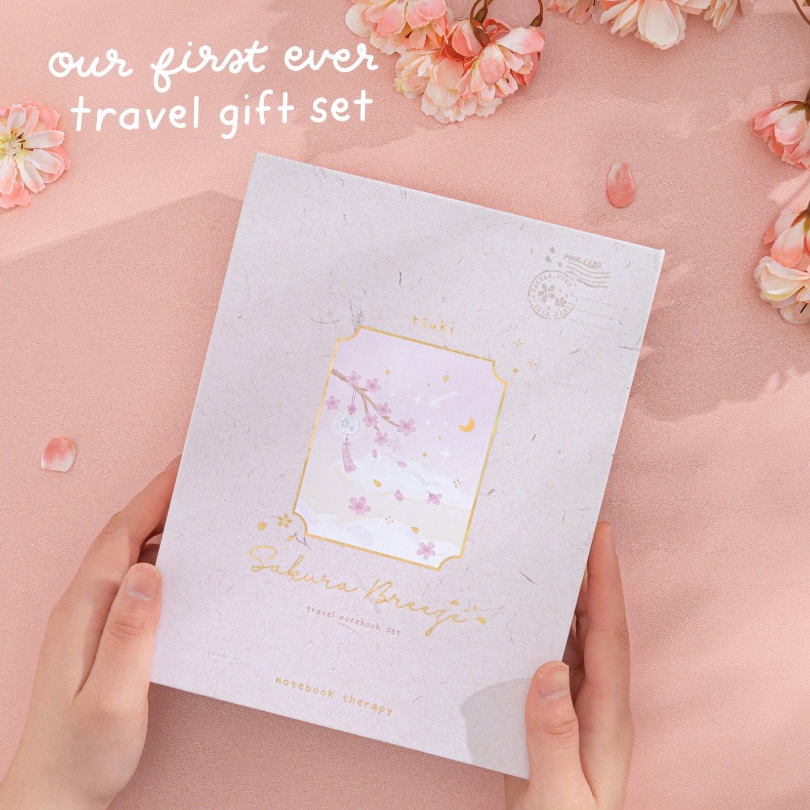 Hands holding Sakura Breeze travel gift sset box with tex “our first ever travel gift set”
