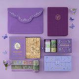 Flatlay of Tsuki Enchanted Garden collection including a purple notebook pouch, lavender design bullet journal, fairycore stamps, fairycore washi tape set and fairycore scrapbook bundle