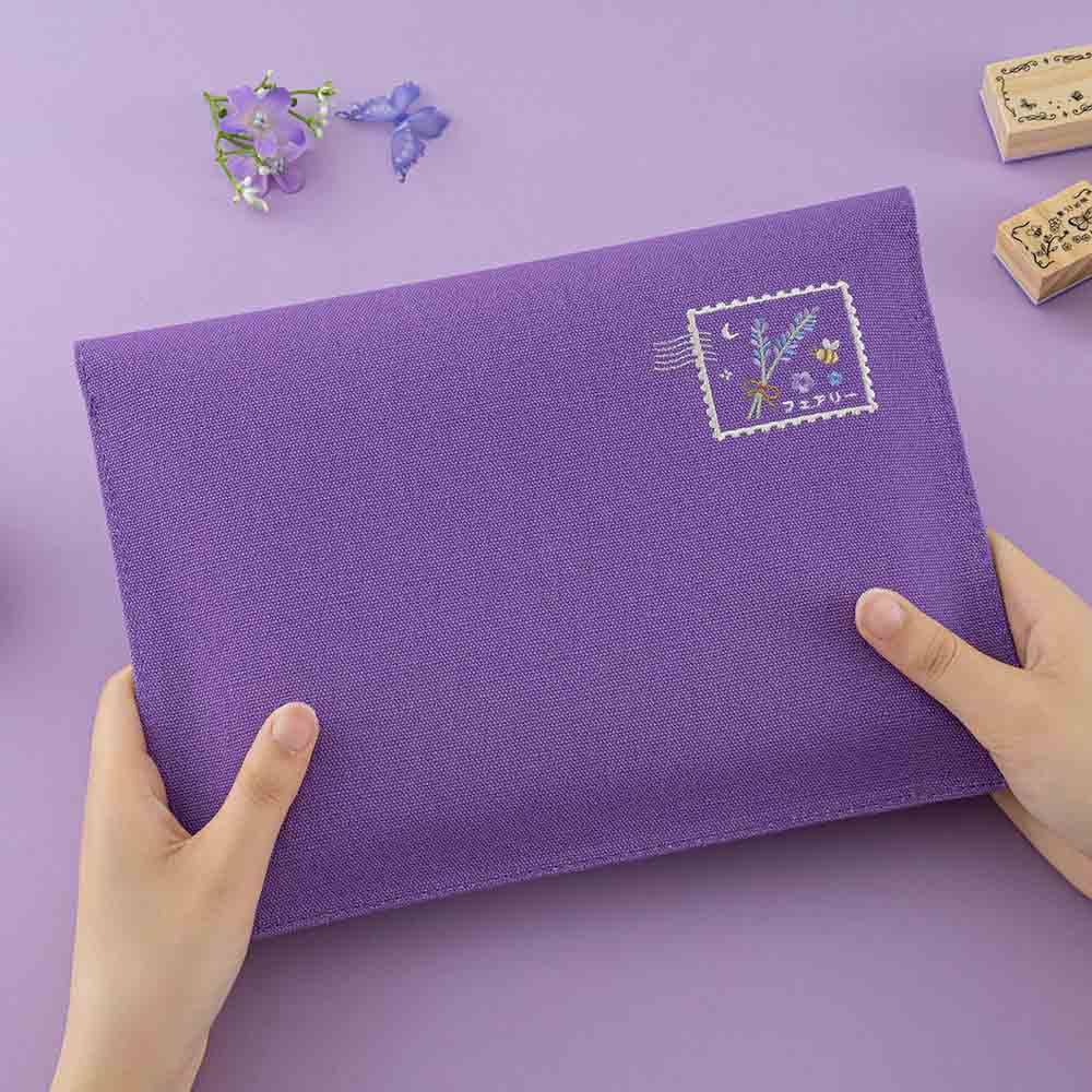 Back design of the envelope pouch features an embroidered stamp design with lavender and bee