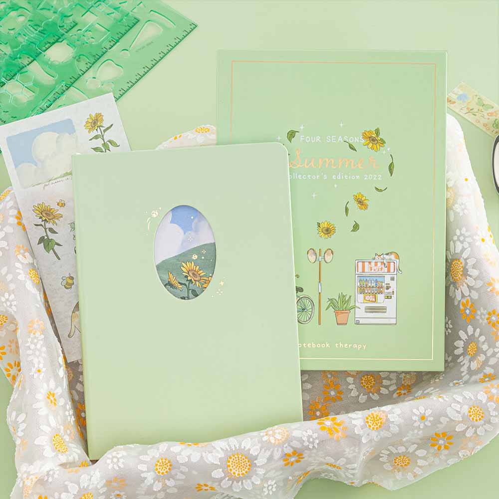 Tsuki Four Seasons Summer Collectors Edition 2022 sage bullet journal notebook in a basket with daisy patterned lining 