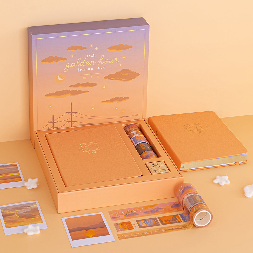 Tsuki Golden Hour Bullet Journal  Box set in orange background with sunset polaroids scattered on  the table