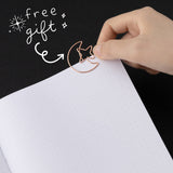 Moon paperclip at the edge of dotted bullet journal page with white lettering that says “free gift”
