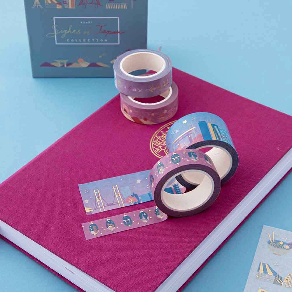 4 washi tape rolls on pink linen notebook