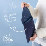 Model holding Cloud Dreamland notebook pouch at an angle showing magnetic button closure