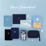 Cloud Dreamland collection flatlay on sky blue background including 3 notebooks, stamp set, washi tape set, travel pouch, notebook pouch and scrapbook set