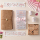 Flatlay of Hinoki travel notebook with hinoki into the blossom mixed insert + sticker set, washi tapes and stamps