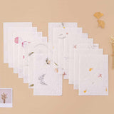 Tsuki Handmade Petal Paper Pack with polaroid picture and autumn leaves on beige background