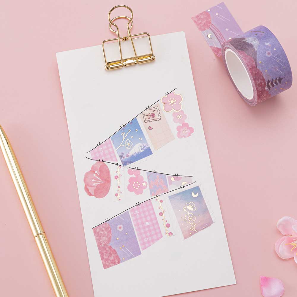 Tsuki ‘Sakura Journey’ Washi Tapes on white clipboard with gold pen and cherry blossom petals on light pink background