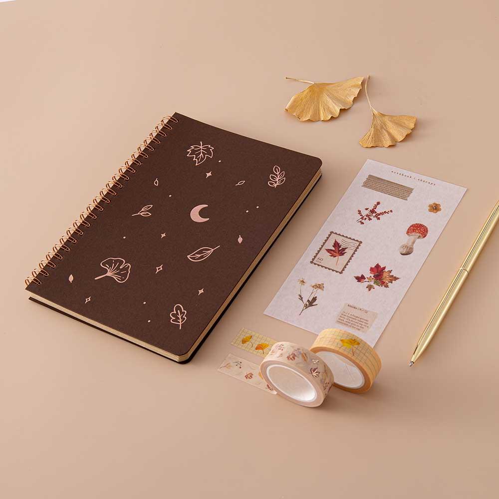 Tsuki ‘Maple Dreams’ Kraft Paper Ringbound Bullet Journal with free autumn sticker sheet and Tsuki ‘Maple Dreams’ Washi Tapes with autumn leaves and gold pen on beige background