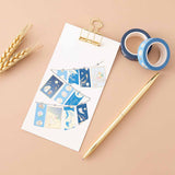Tsuki ‘Moonlit Wish’ Washi Tapes on white clipboard with gold pen with wheat reeds on light brown background
