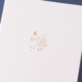 Close up of the front cover of Tsuki ‘Suzume’ Winter Limited Edition Bullet Journal on navy background