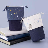 Tsuki ‘Dreams of Snow’ Pop-Up Pencil Cases in Starry Night and Playful Penguin with Tsuki ‘Winter Wishes’ Limited Edition Bullet Journal and Tsuki ‘Winter Journey’ Limited Edition Bullet Journal and Tsuki ‘Suzume’ Winter Limited Edition Bullet Journal in light blue background