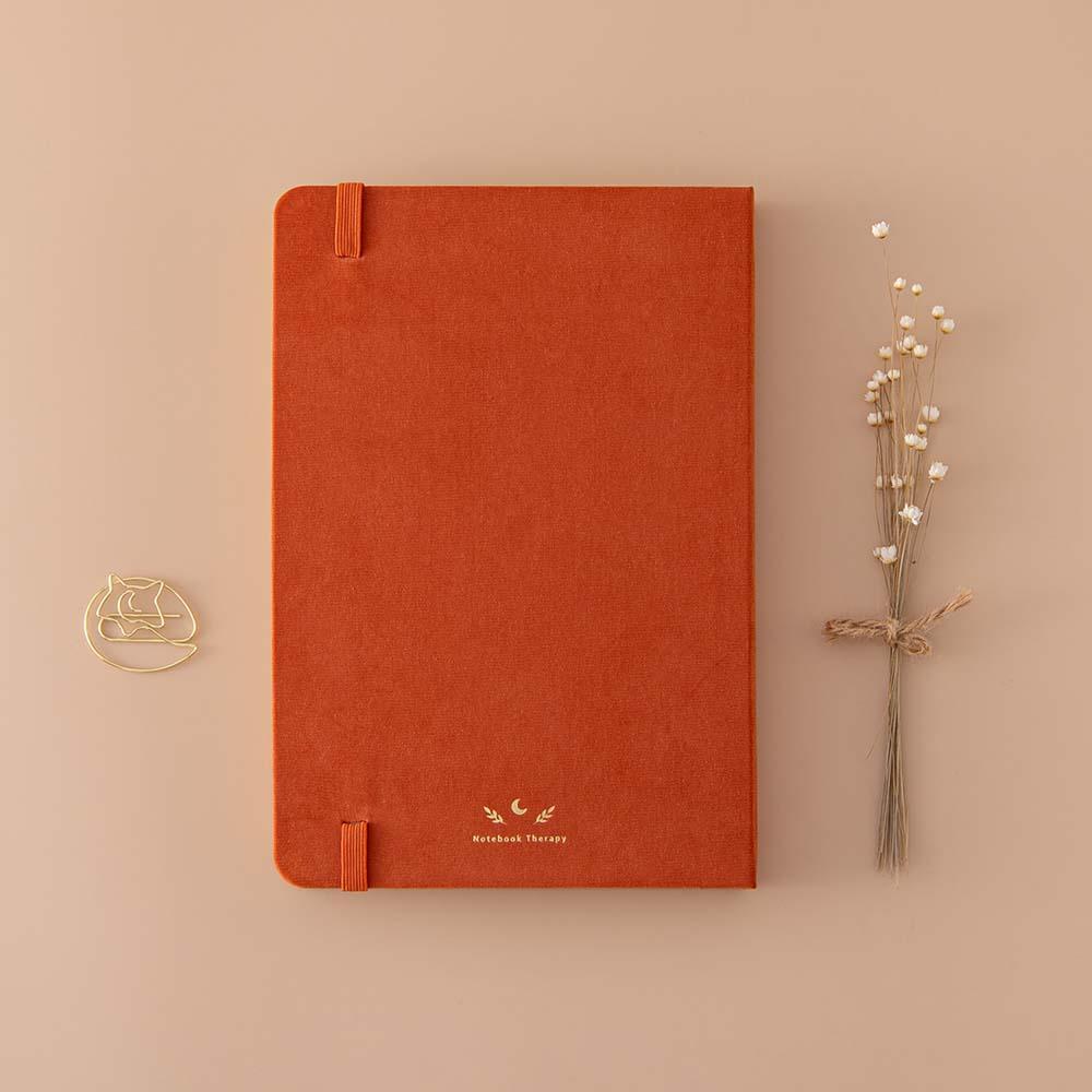 Back cover of Tsuki ‘Kitsune’ Limited Edition Fox Bullet Journal with free paperclip gift with dried flowers on beige background