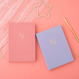 Tsuki ‘Full Bloom’ Limited Edition Bullet Journal with Tsuki ‘Suzume’ Limited Edition Notebook with free gifts and pen with netting on coral pink background