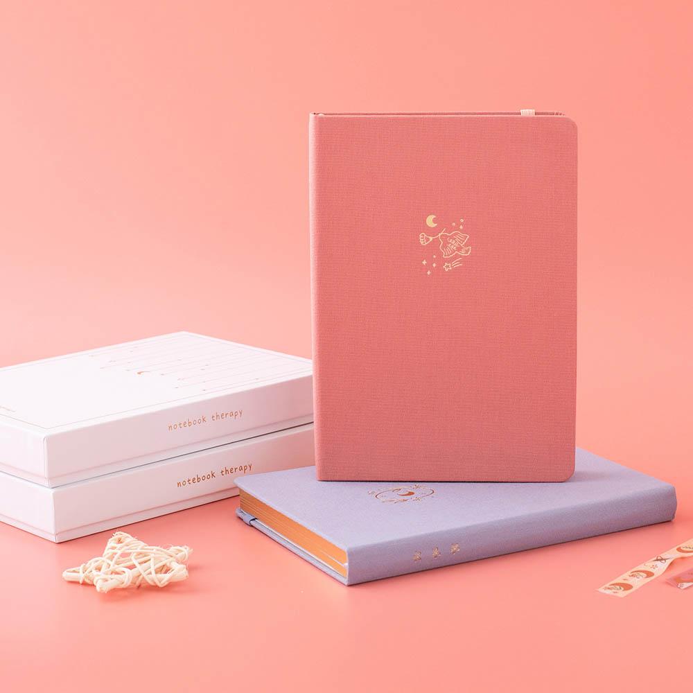 Tsuki ‘Suzume’ Limited Edition Bullet Journal with Tsuki ‘Full Bloom’ Limited Edition Notebook with luxury eco-friendly box packaging and star and Tsuki ‘Moonflower’ Washi Tape on coral pink background