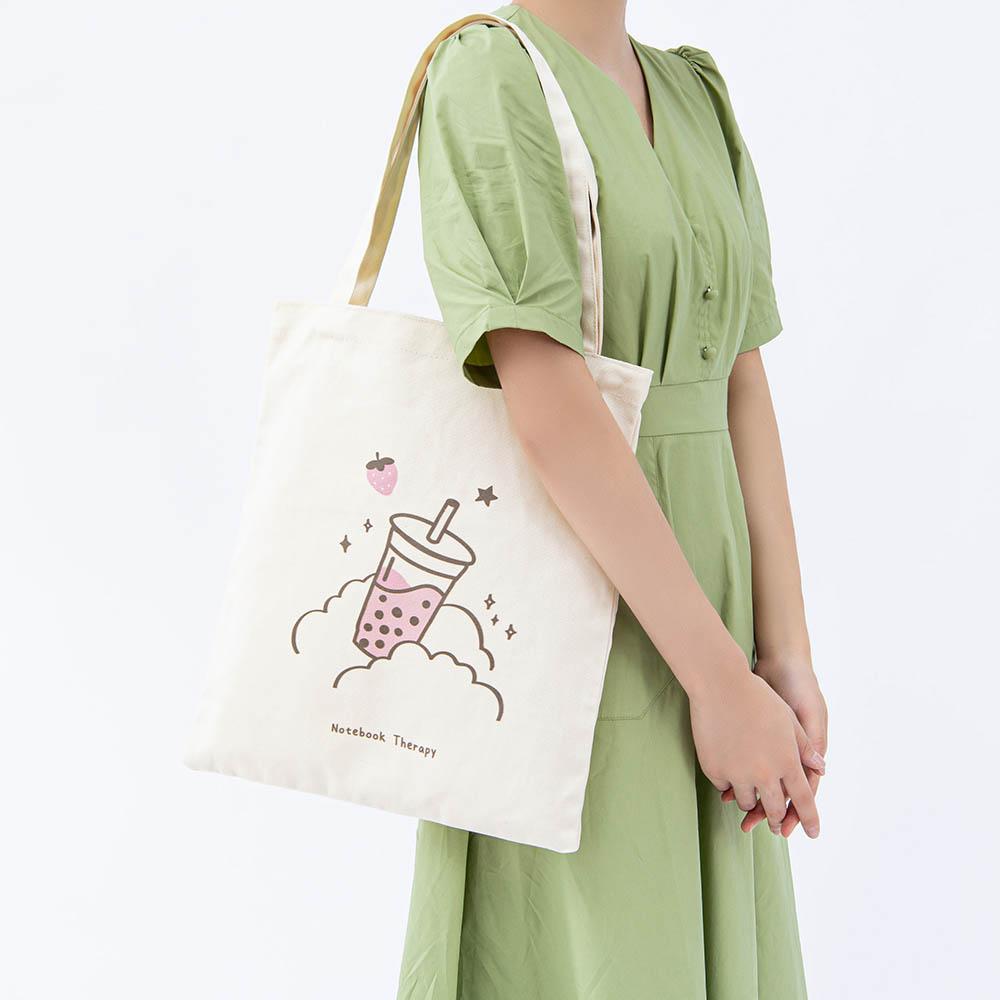 Tsuki ‘Ichigo’ Boba Tote Bag shown on model’s arm in light grey background