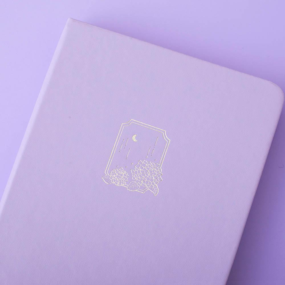 Close up of the front cover of Tsuki Endless Summer Limited Edition Bullet Journal in Lilac Bloom on lilac background