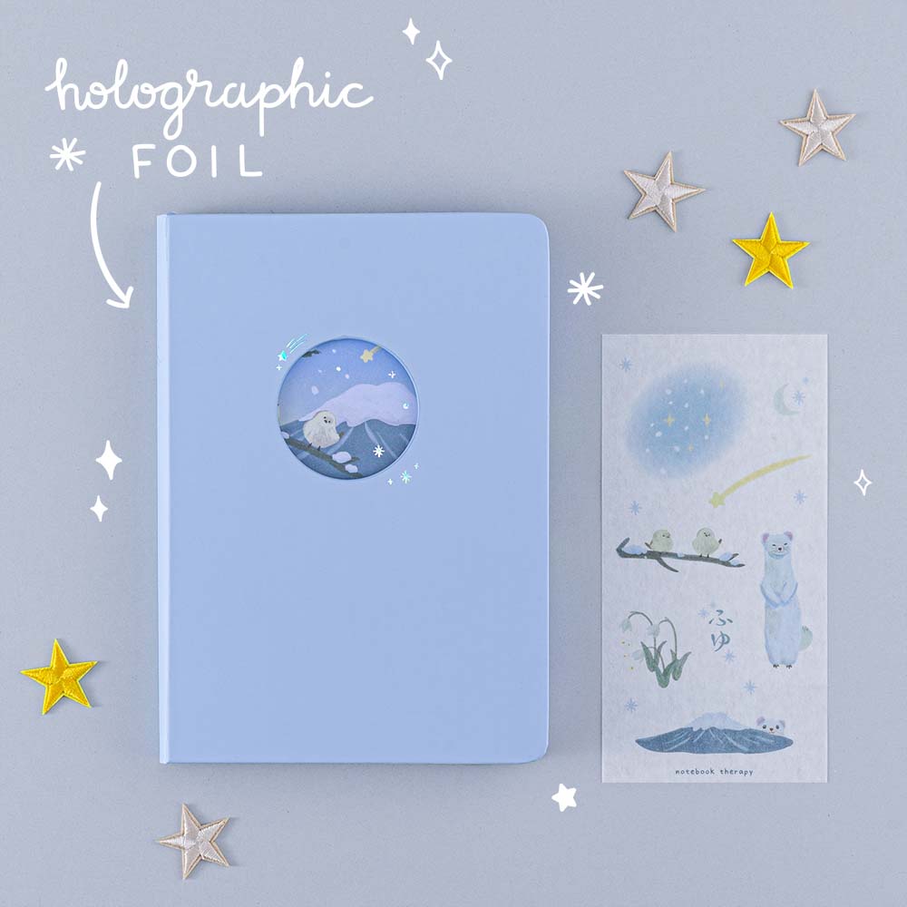 Tsuki Four Seasons Winter Collector’s Edition Bullet Journal with free stickers sheet and holographic foil with stars on light blue background