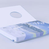 Close up of Tsuki Four Seasons Winter Collector’s Edition Bullet Journal with open front cover on light blue background 