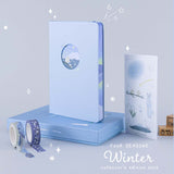 Tsuki Four Seasons Winter Collector’s Edition Bullet Journal with eco-friendly gift box and free stickers sheets with Dreams of Snow Holographic Washi Tape Set and Dreams of Snow Bullet Journal Stamp Set in light blue background