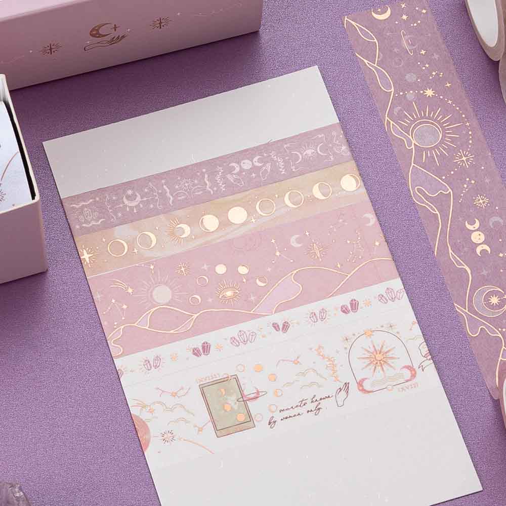 Close up of Tsuki ‘Moonlit Blush’ Washi Tapes rolled out on white paper with amethyst stones on purple background