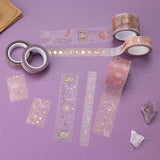Close up of Tsuki ‘Moonlit Blush’ Washi Tapes with rose gold details rolled out with amethyst stones on purple background