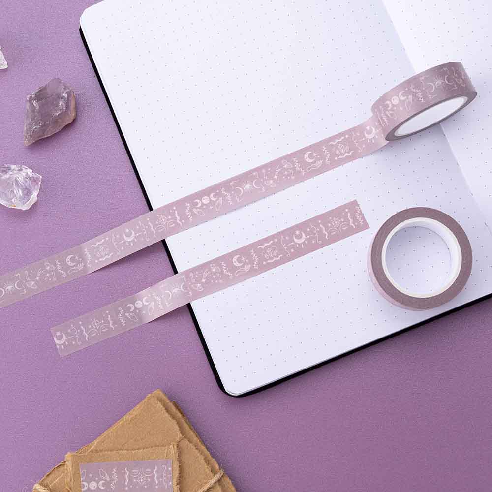 Tsuki ‘Moonlit Blush’ Washi Tapes rolled out on open bullet journal page with amethyst stones and scrapbook paper on purple background