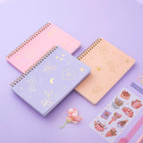 Sakura Pink, Lilac taro and honey Peach Tsuki Floral ringbound bullet journal with free sticker sheet on lilac background