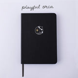 Tsuki Black Paper Limited Edition Hardcover Bullet Journal in Playful Orca on white background