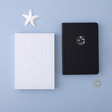 Tsuki deep black Playful Orca limited edition notebook with eco-friendly gift box and starfish and free sunshine gift on blue background