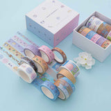 Close up of Tsuki ‘Four Seasons’ Washi Tape Set by Notebook Therapy x Milkkoyo rolled out with white flower on light blue background