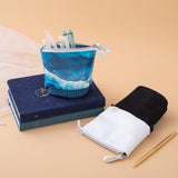 Tsuki Ocean Edition pop up standing pencil cases in Orca Black and Ocean Blue at an angle with sea green textured vegan leather Dolphin Days notebook and deep blue Gentle Giant luxury edition notebook with pen in peach background
