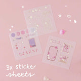 Three free sticker sheets from Tsuki ‘Sakura Journey’ Washi Tape Set with cherry blossom petals on light pink background