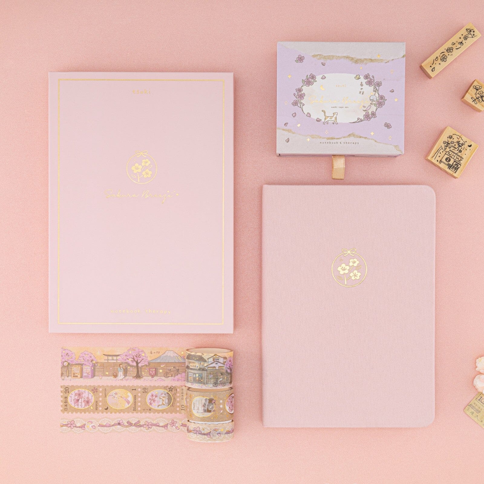 Flatlay of Tsuki Sakura Breeze limited edition bullet journal by Notebook Therapy and washi tapes