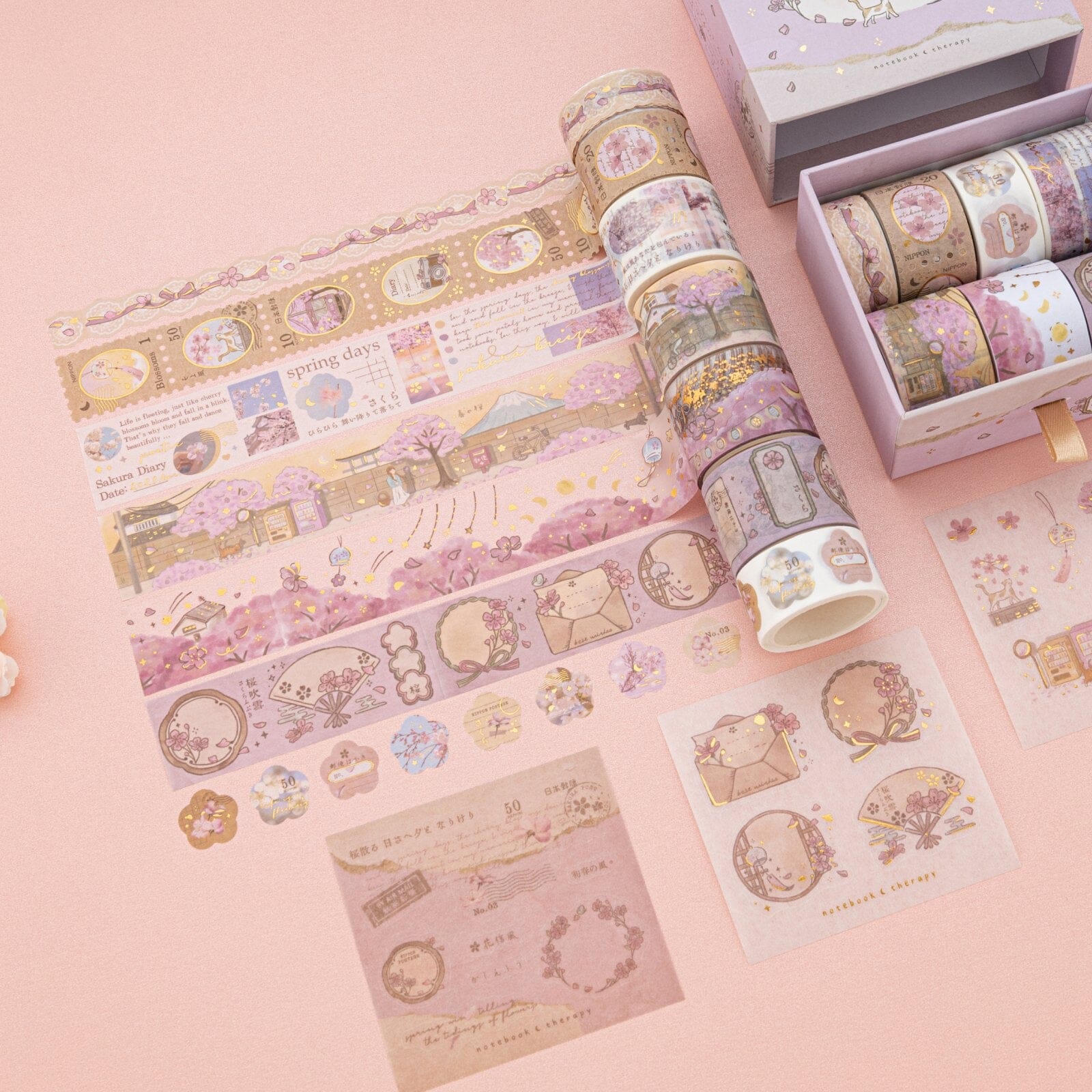 Sakura Breeze washi tape rolls on pink background