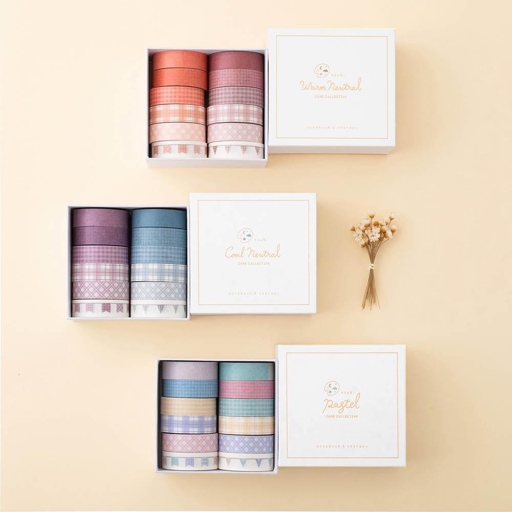 Tsuki Core Washi Tape Sets in Cool Neutral and Warm Neutral and Pastel with luxury eco-friendly gift box packaging and flowers on beige background