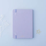 Back cover of Tsuki ‘Full Bloom’ Limited Edition Bullet Journal with free gift and flowers on lilac background