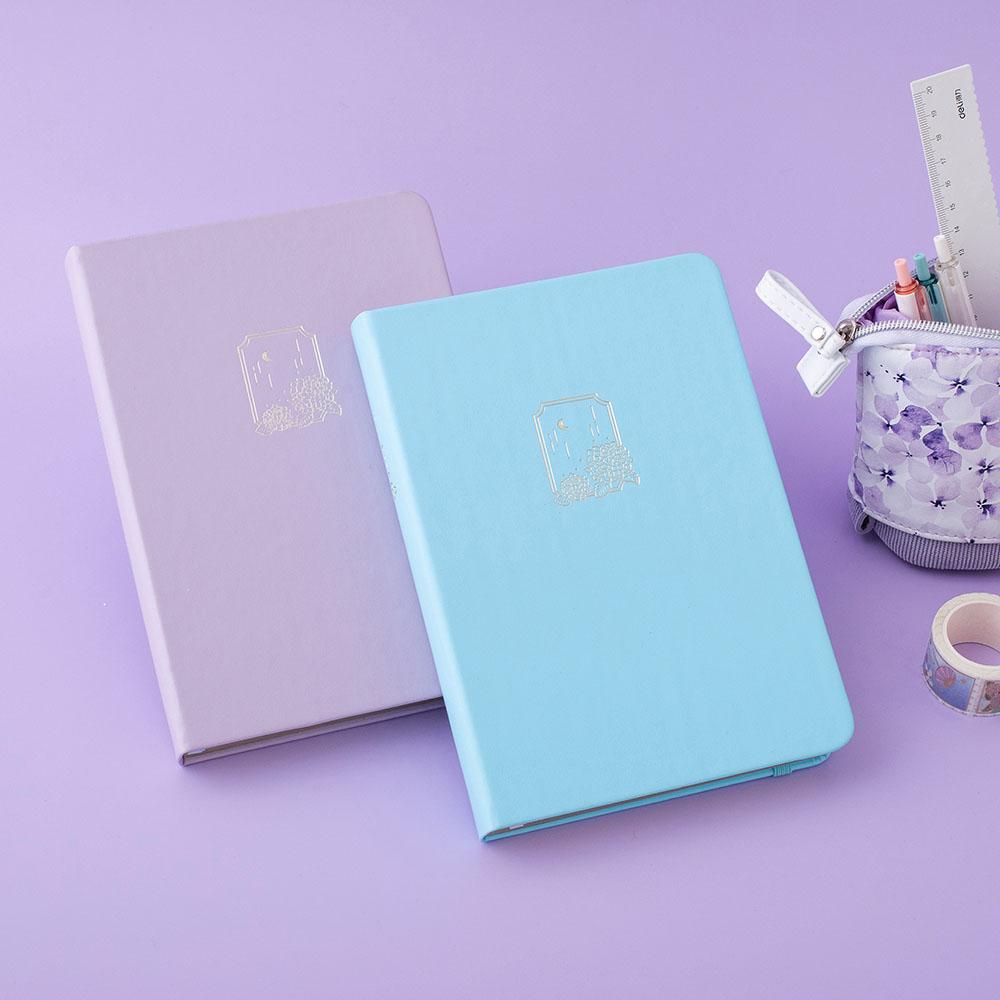 Tsuki Endless Summer Limited Edition Bullet Journals in Lilac Bloom and Petal Blue with Tsuki Endless Summer washi tape roll with Tsuki Endless Summer Pop-Up Pencil case in lilac bloom on lilac background