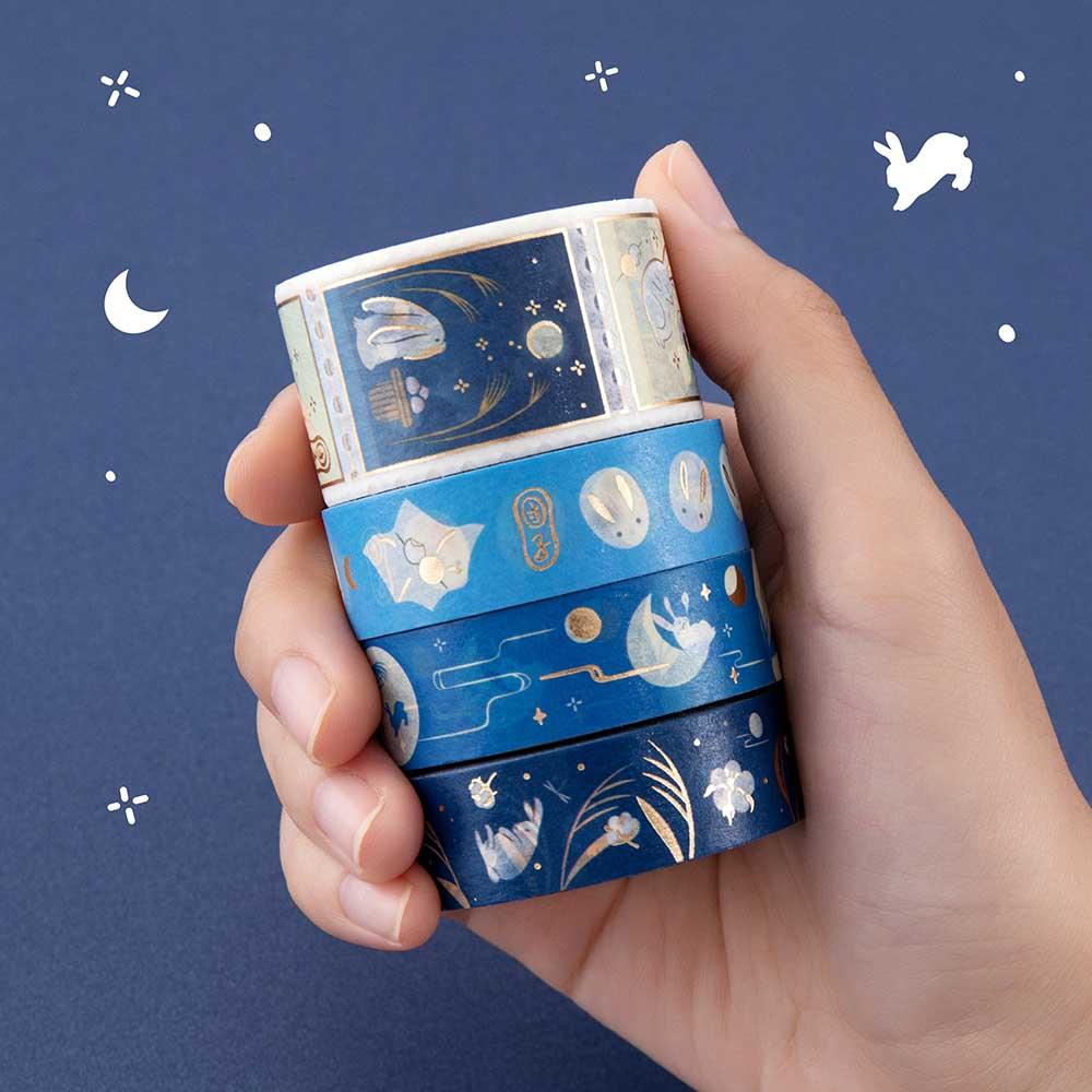 Close up of Tsuki ‘Moonlit Wish’ Washi Tape Set held in hand in dark blue background