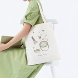 Tsuki ‘Matcha Matcha’ Tote Bag shown on model’s arm in light grey background