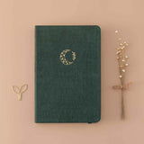 Tsuki ‘Midnight Garden’ Limited Edition Bullet Journal with free paperclip gift and dried flowers on beige background