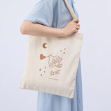 Tsuki ‘Moonflower’ Limited Edition Tote Bag shown on model’s arm on light blue background