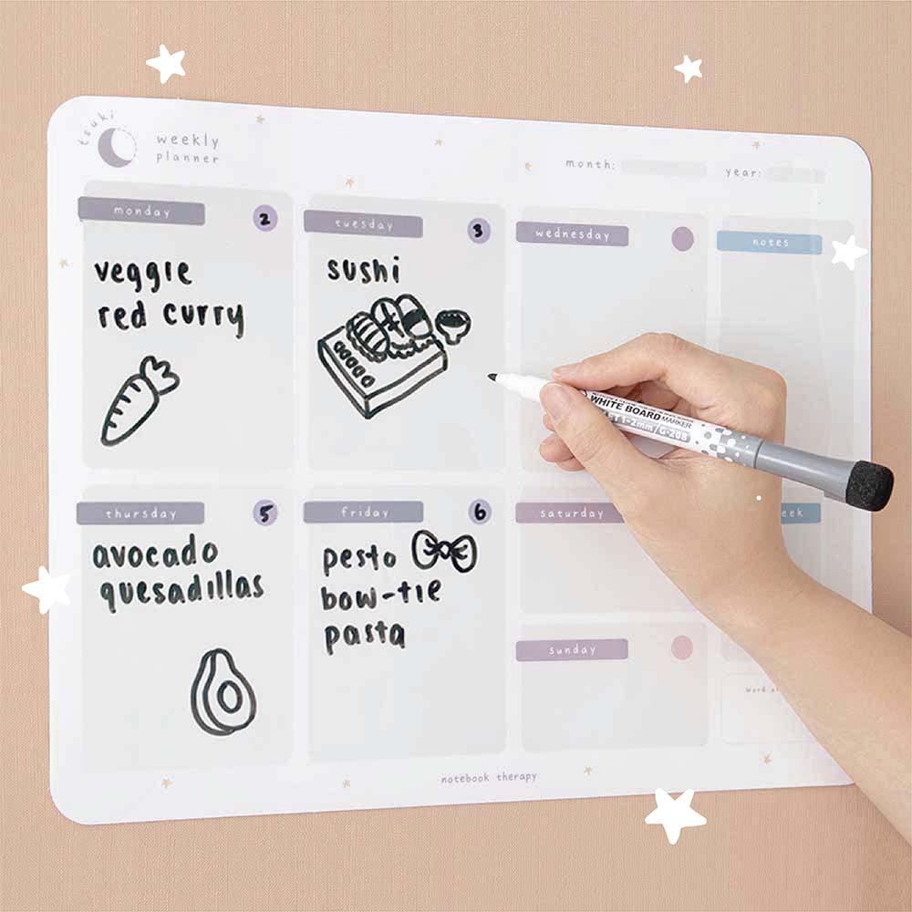 Tsuki Reusable Weekly Planner on smooth wallpaper surface with dry erase marker held in hand