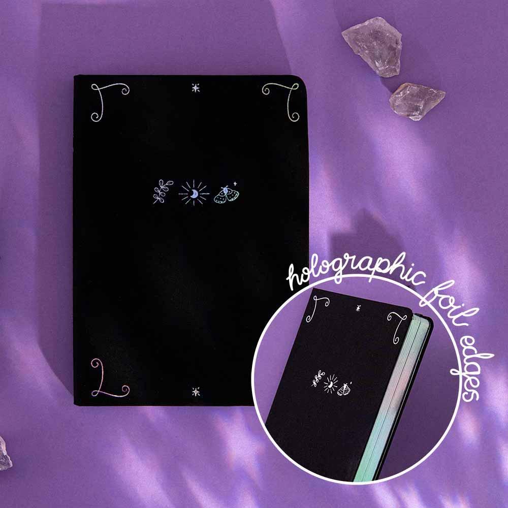 Tsuki ‘Moonlit Spell’ Limited Edition Holographic Bullet Journal with holographic foil page edges with amethyst stones on purple background